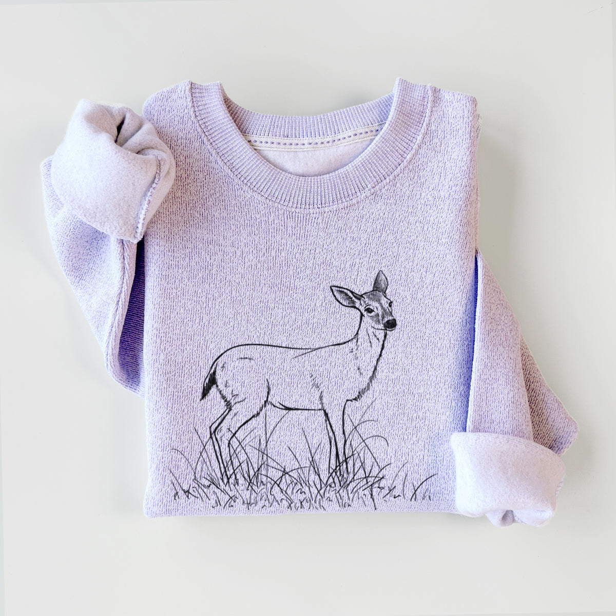 Ice purple knit sweatshirt printed with a black ink sketch of a black-tailed deer standing in tall grass, styled flat.