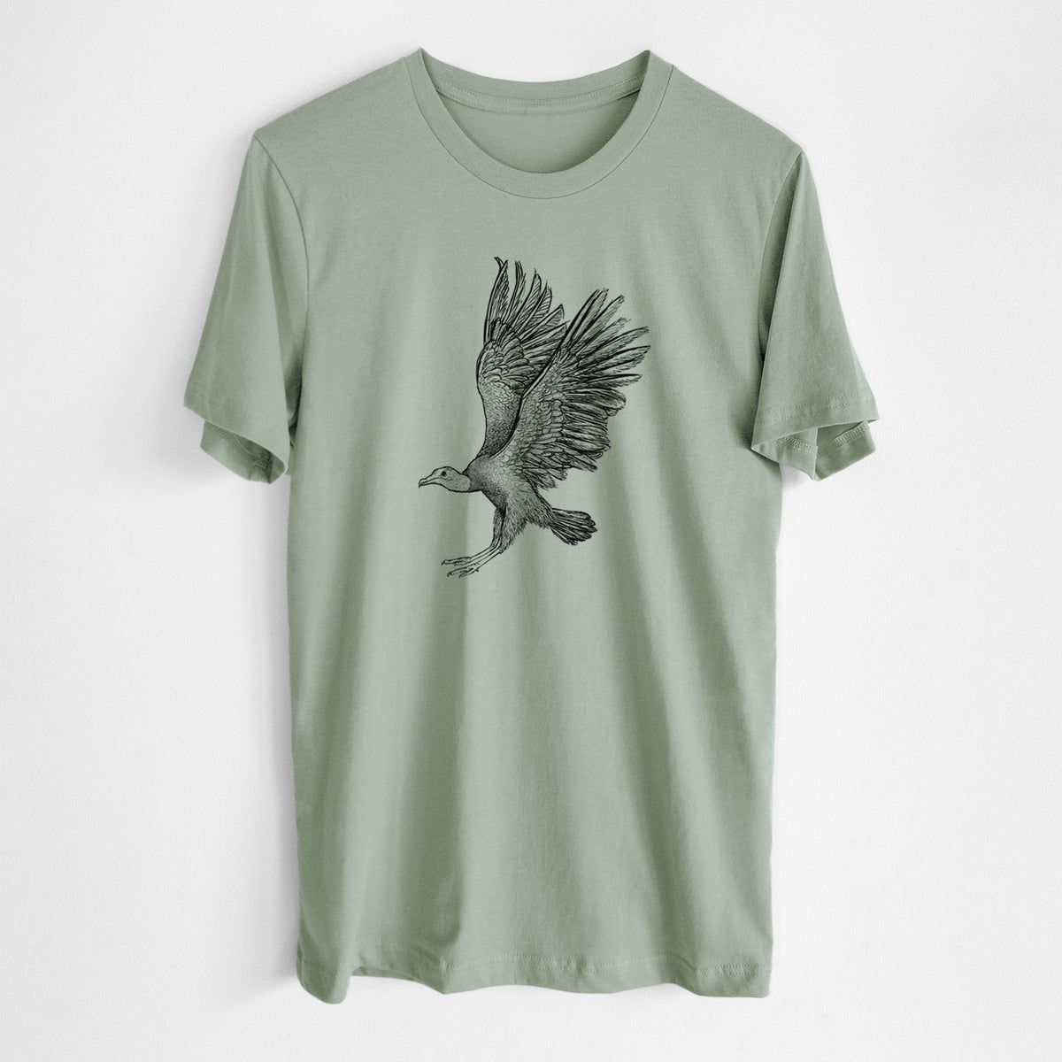 Sage green lightweight cotton t-shirt laid flat, printed with a detailed black ink illustration of a black vulture landing with its wings spread.