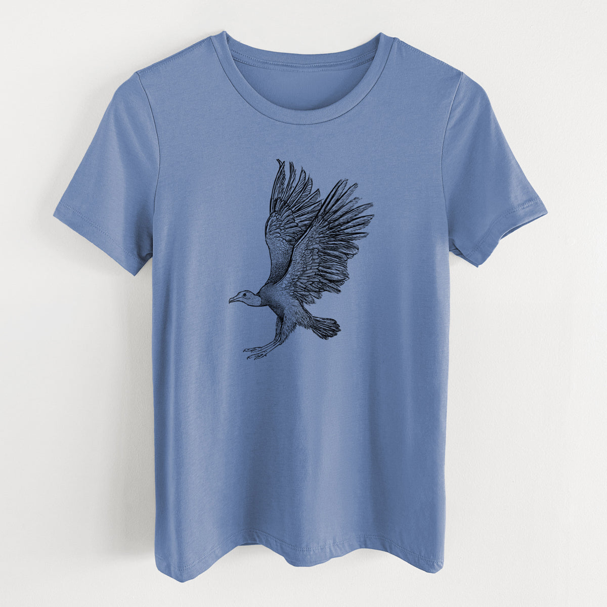 Blue bell women's relaxed fit cotton t-shirt laid flat, printed with a detailed black ink illustration of a black vulture landing with its wings spread.