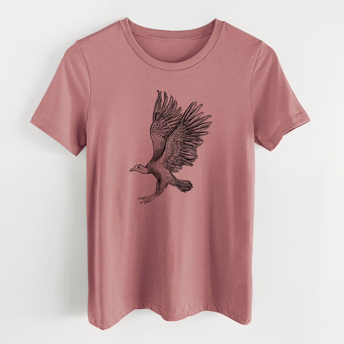 Mauve pink women's relaxed fit cotton t-shirt laid flat, printed with a detailed black ink illustration of a black vulture landing with its wings spread.