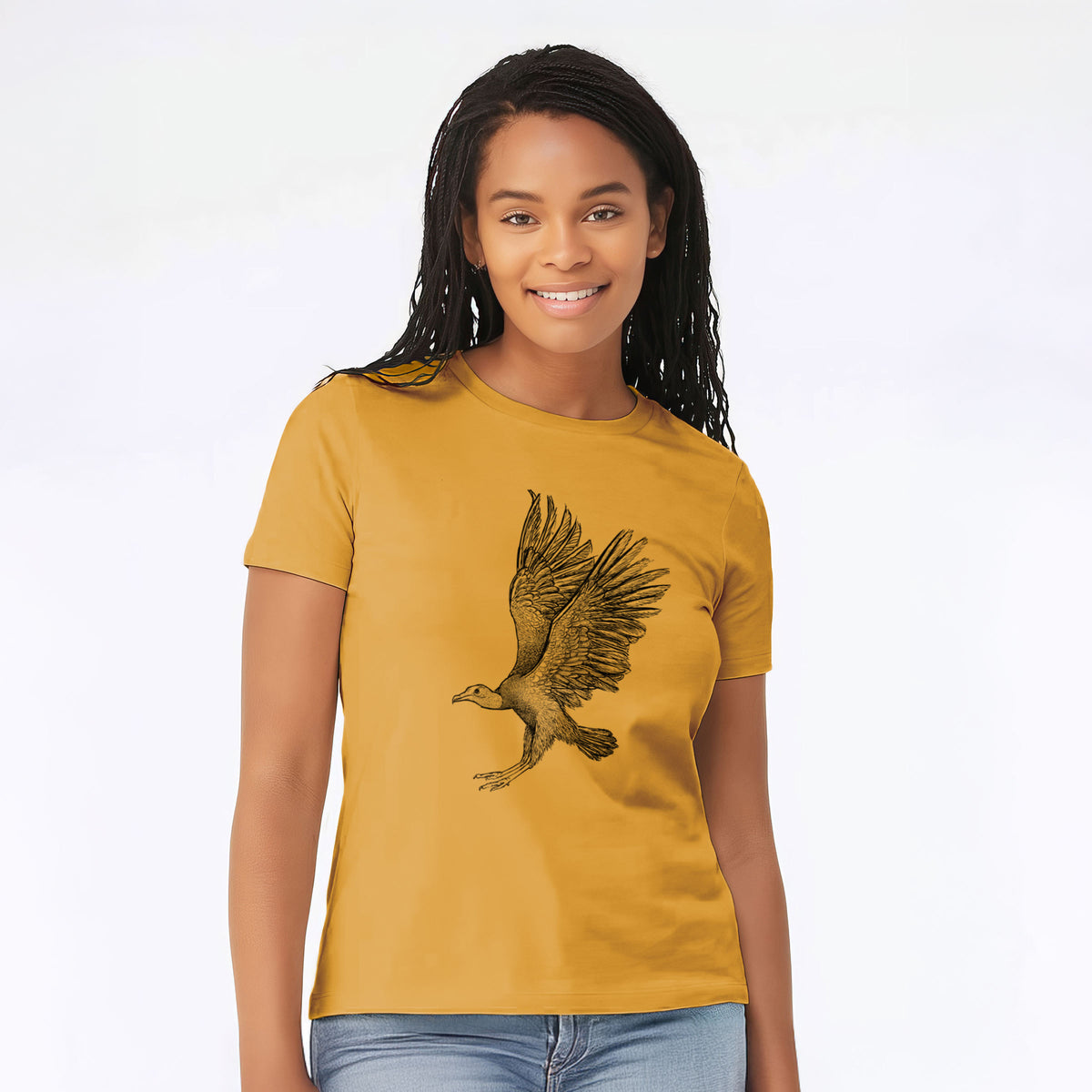 Woman wearing a mustard yellow women's relaxed fit cotton t-shirt printed with a detailed black ink illustration of a black vulture landing with its wings spread.