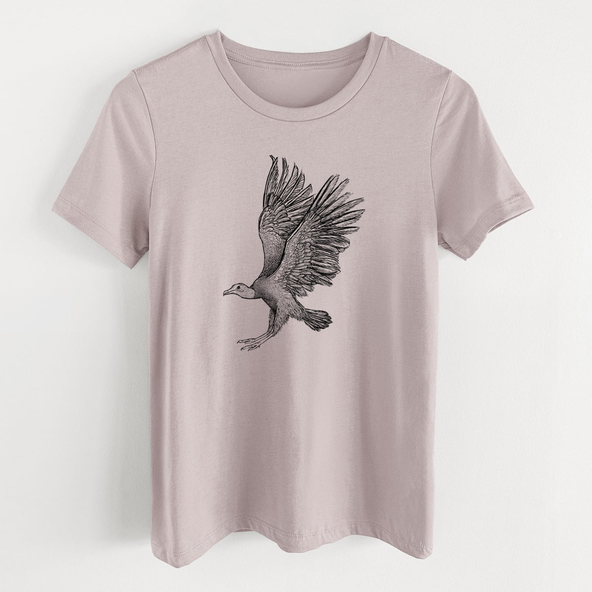 Pink gravel women's relaxed fit cotton t-shirt laid flat, printed with a detailed black ink illustration of a black vulture landing with its wings spread.