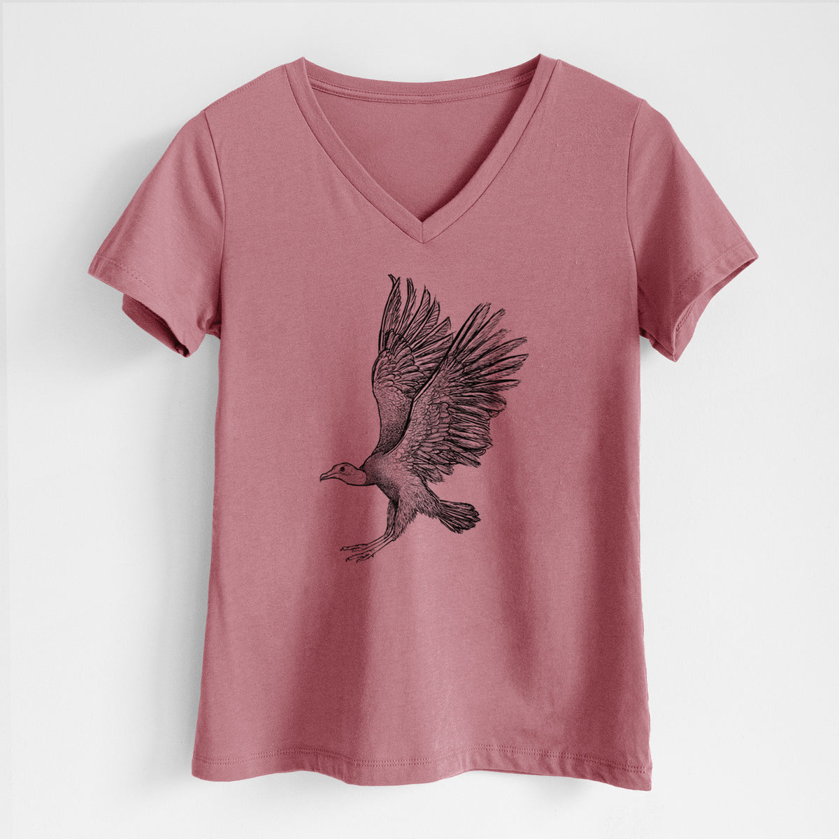 Mauve pink women's relaxed fit cotton V-neck t-shirt laid flat, printed with a detailed black ink illustration of a black vulture landing with its wings spread.