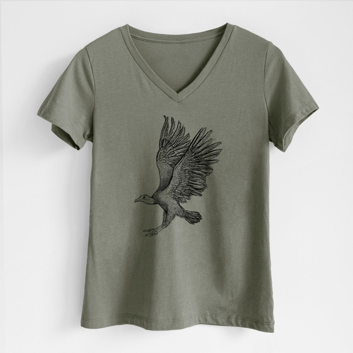 Military green women's relaxed fit cotton V-neck t-shirt laid flat, printed with a detailed black ink illustration of a black vulture landing with its wings spread.