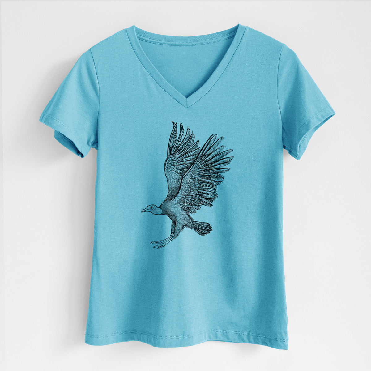 Turquoise women's relaxed fit cotton V-neck t-shirt laid flat, printed with a detailed black ink illustration of a black vulture landing with its wings spread.
