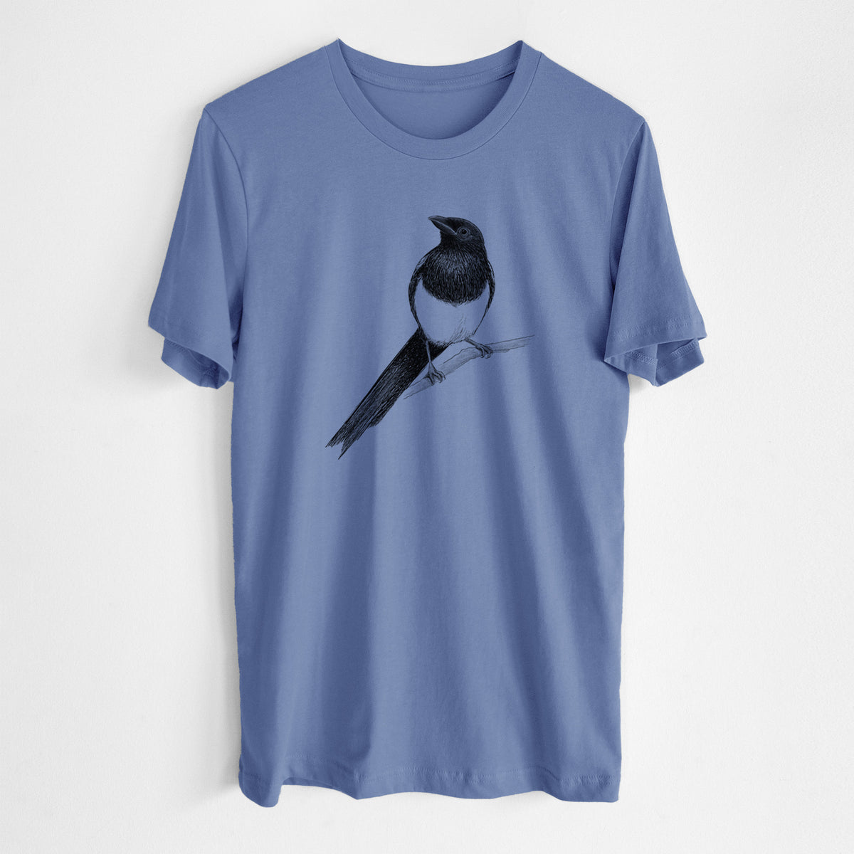Blue bell lightweight cotton t-shirt laid flat, printed with a detailed black ink sketch of a black-billed magpie perched on a branch with its long tail.