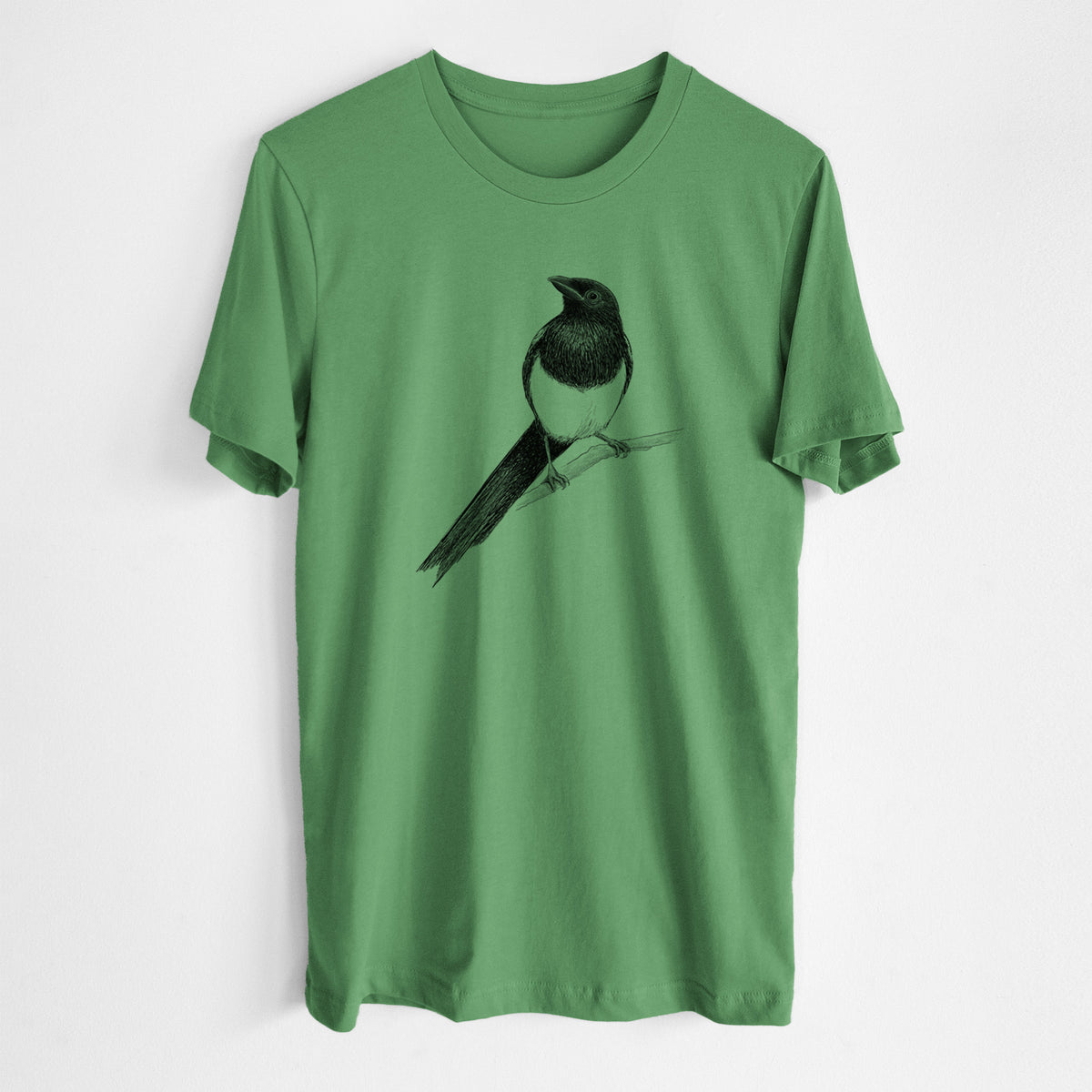 Leaf green lightweight cotton t-shirt laid flat, printed with a detailed black ink sketch of a black-billed magpie perched on a branch with its long tail.