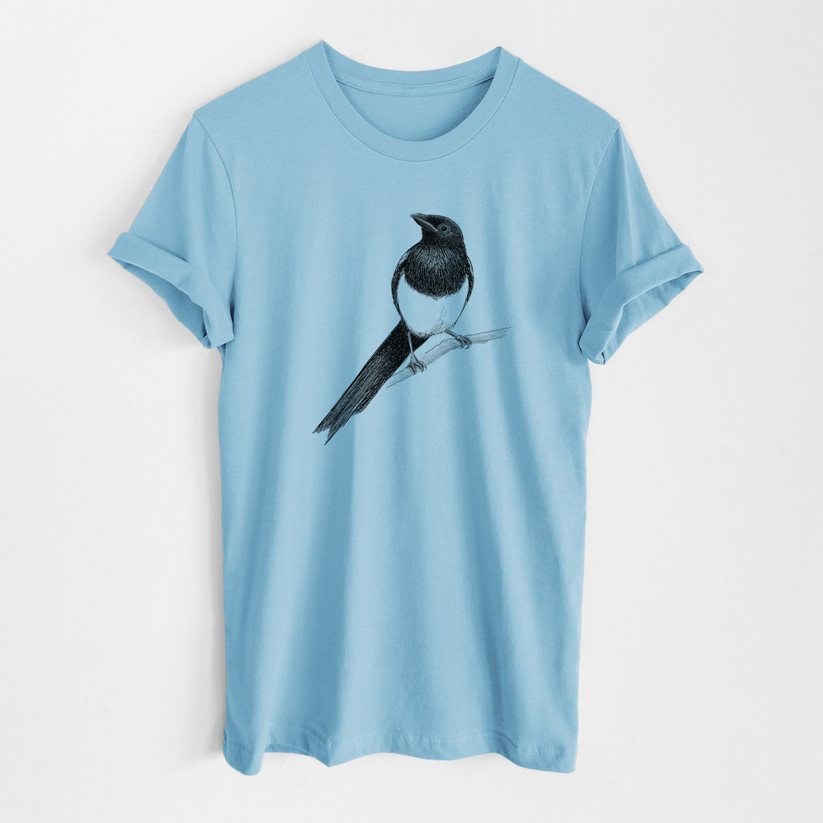 Ocean blue lightweight cotton t-shirt laid flat, printed with a detailed black ink sketch of a black-billed magpie perched on a branch with its long tail.