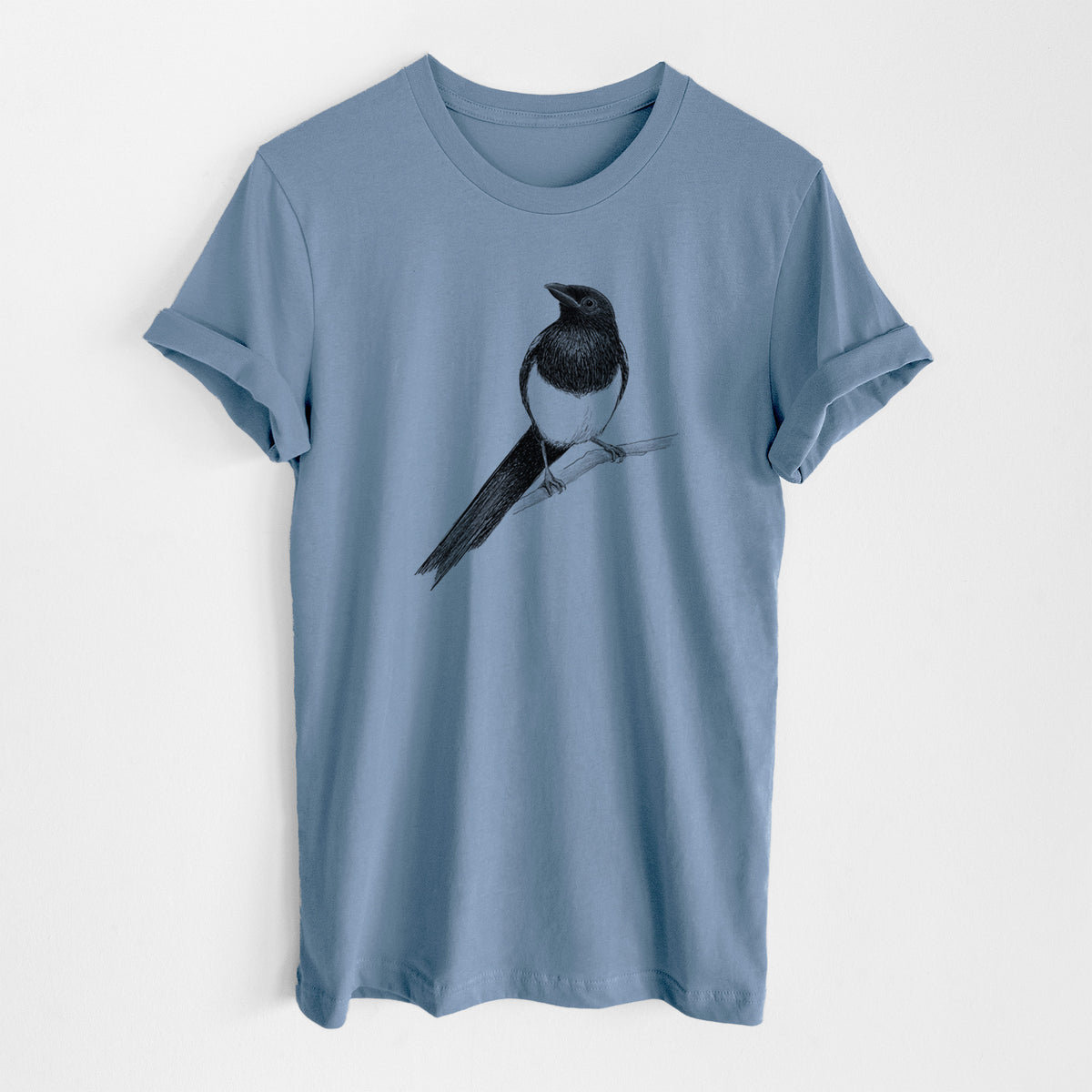 Steel blue lightweight cotton t-shirt laid flat, printed with a detailed black ink sketch of a black-billed magpie perched on a branch with its long tail.