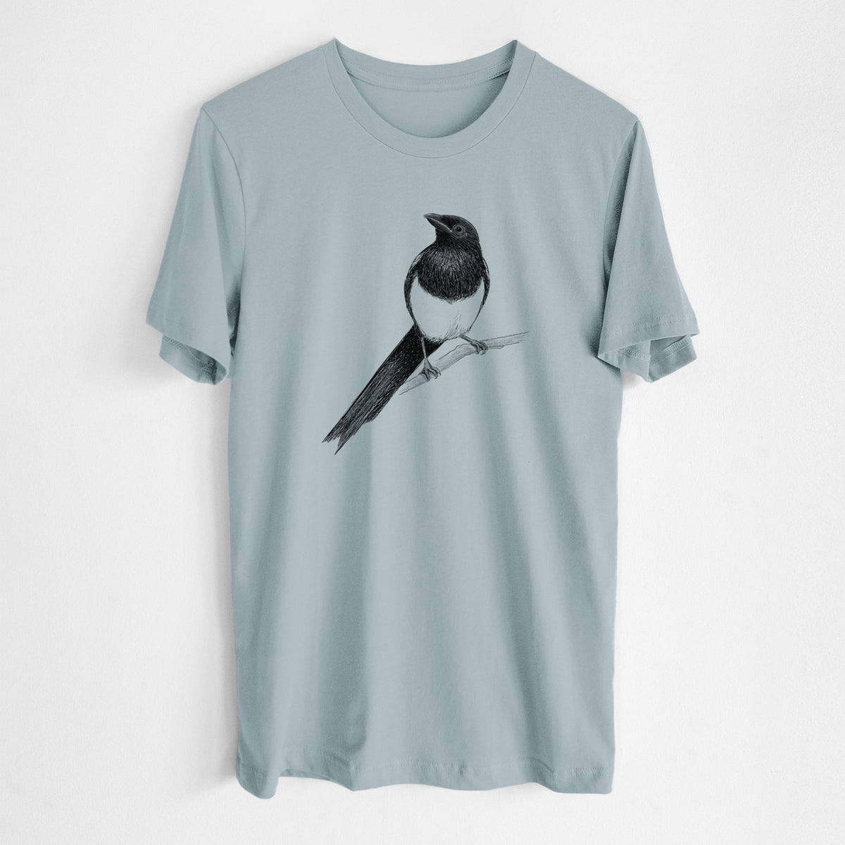 Vintage denim lightweight cotton t-shirt laid flat, printed with a detailed black ink sketch of a black-billed magpie perched on a branch with its long tail.