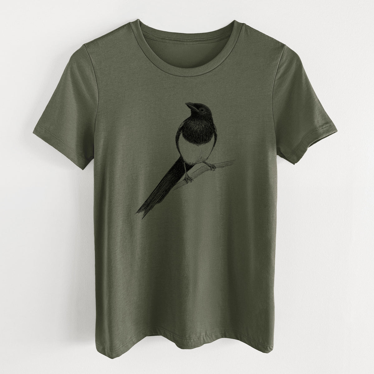 Military green women's relaxed fit cotton t-shirt laid flat, printed with a detailed black ink sketch of a black-billed magpie perched on a branch with its long tail.