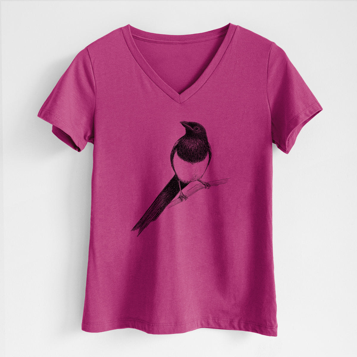 Berry pink women's relaxed fit cotton V-neck t-shirt laid flat, printed with a detailed black ink sketch of a black-billed magpie perched on a branch with its long tail.