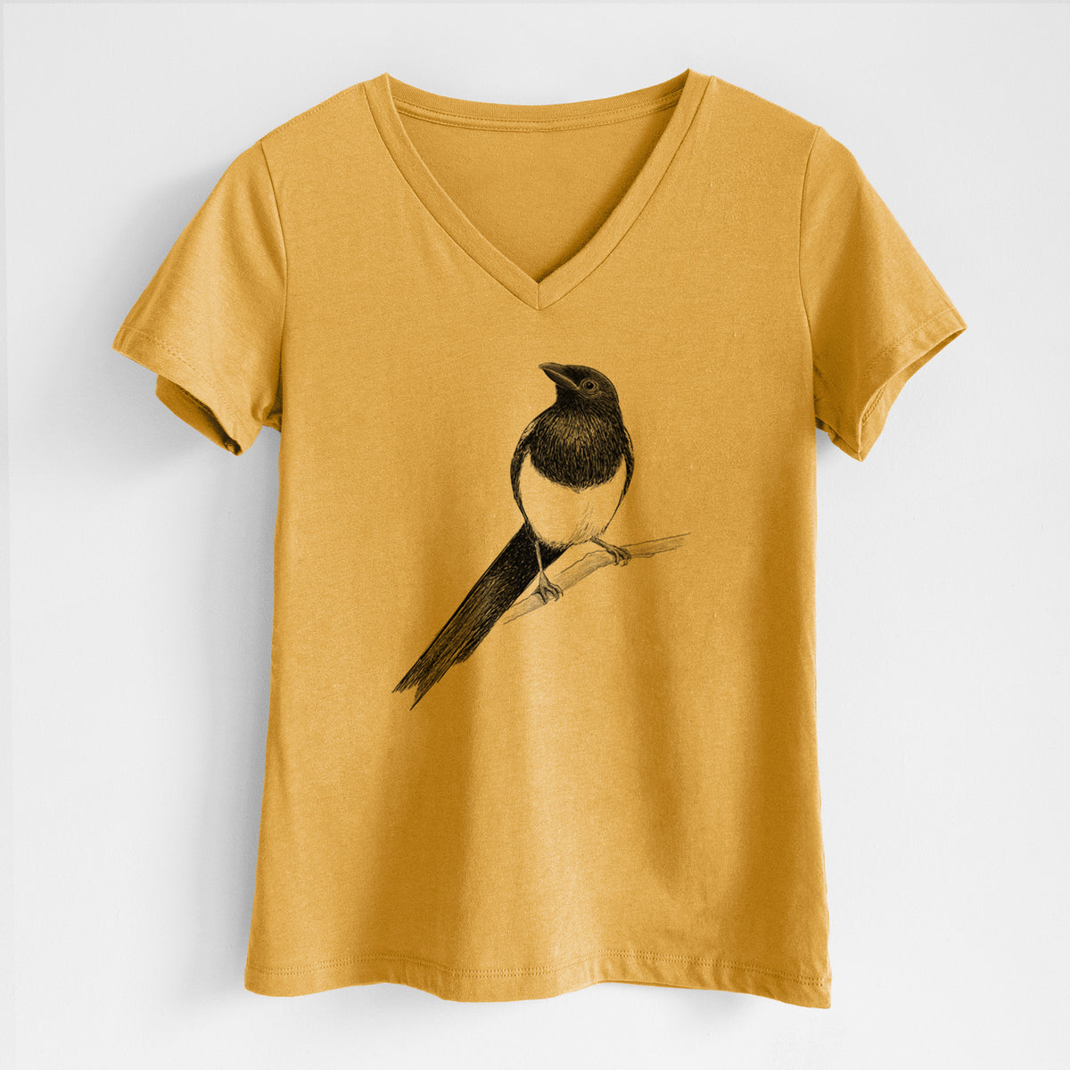 Honeycomb yellow women's relaxed fit cotton V-neck t-shirt laid flat, printed with a detailed black ink sketch of a black-billed magpie perched on a branch with its long tail.