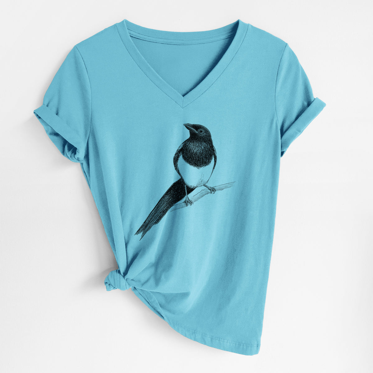 Turquoise women's relaxed fit cotton V-neck t-shirt laid flat, printed with a detailed black ink sketch of a black-billed magpie perched on a branch with its long tail.