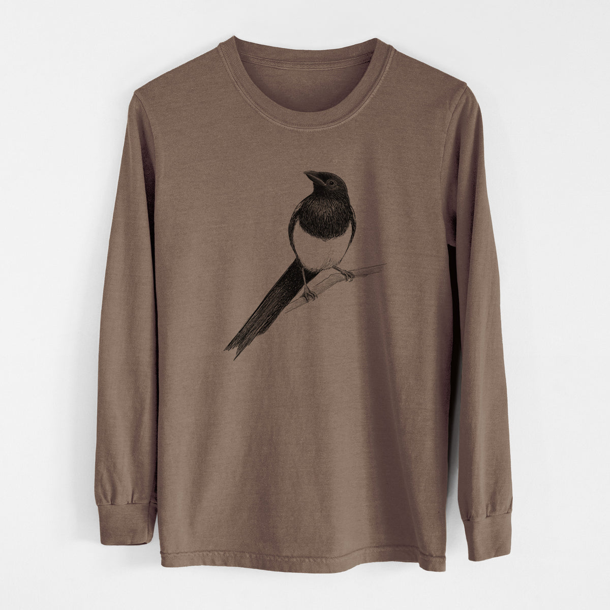 Espresso brown Comfort Colors long sleeve shirt laid flat, printed with a detailed black ink sketch of a black-billed magpie perched on a branch with its long tail.