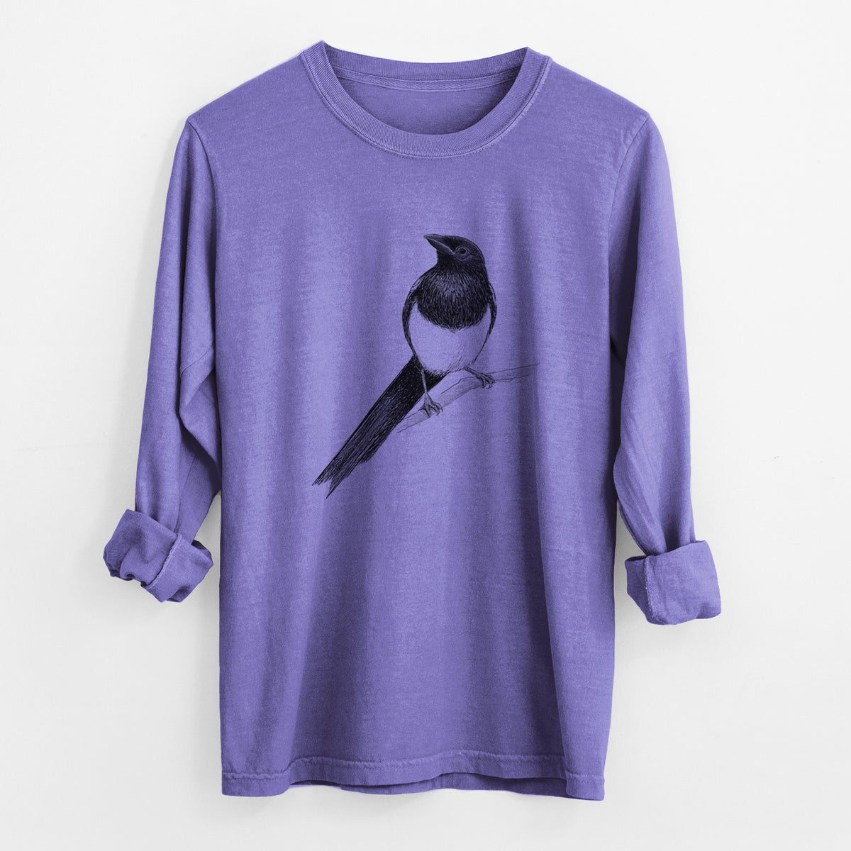 Violet purple Comfort Colors long sleeve shirt laid flat with the cuffs rolled, printed with a detailed black ink sketch of a black-billed magpie perched on a branch with its long tail.