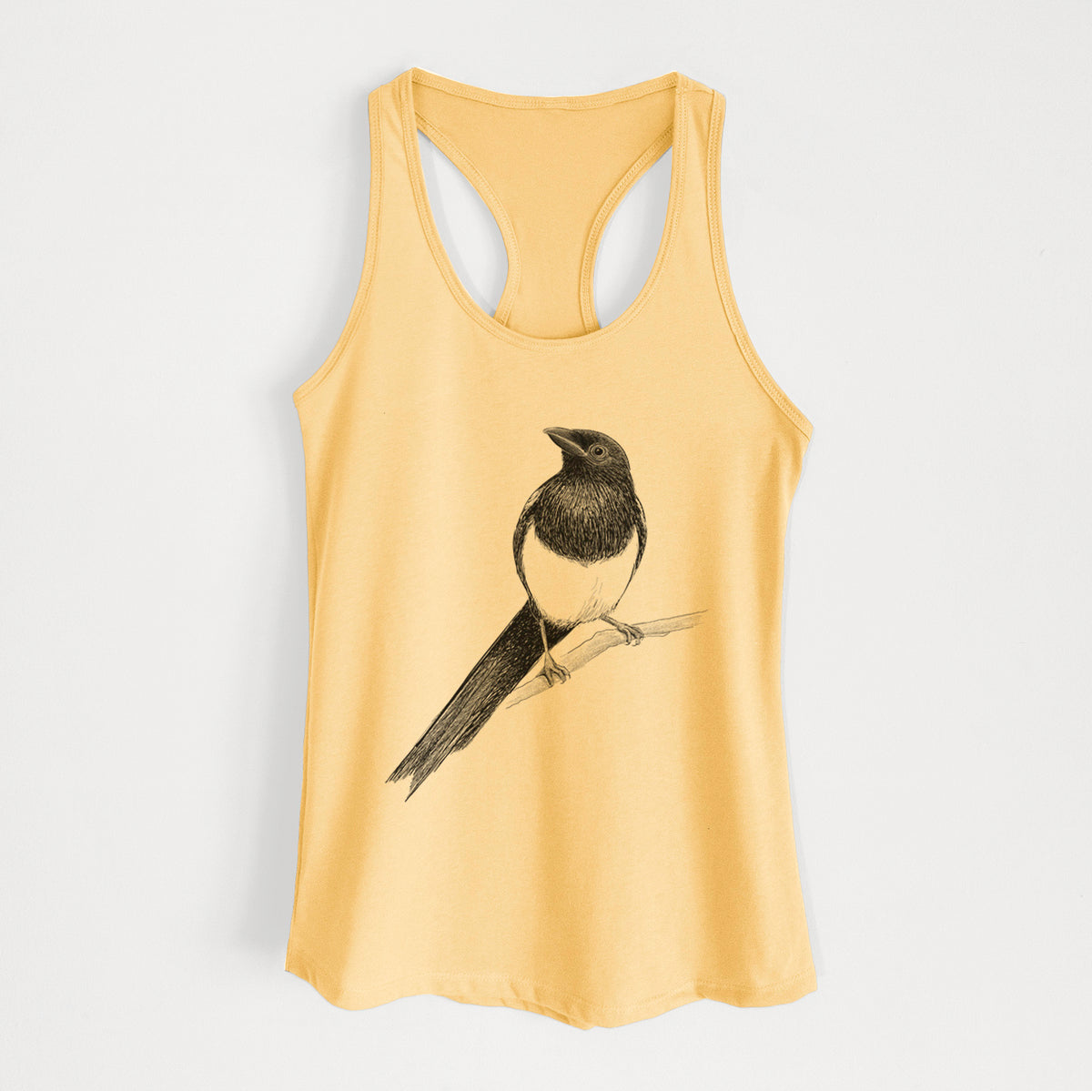 Banana cream women's racerback tank top laid flat, printed with a detailed black ink sketch of a black-billed magpie perched on a branch with its long tail.