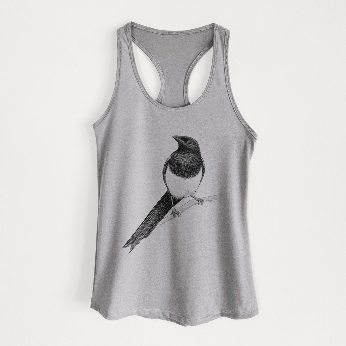 Heather grey women's racerback tank top laid flat, printed with a detailed black ink sketch of a black-billed magpie perched on a branch with its long tail.