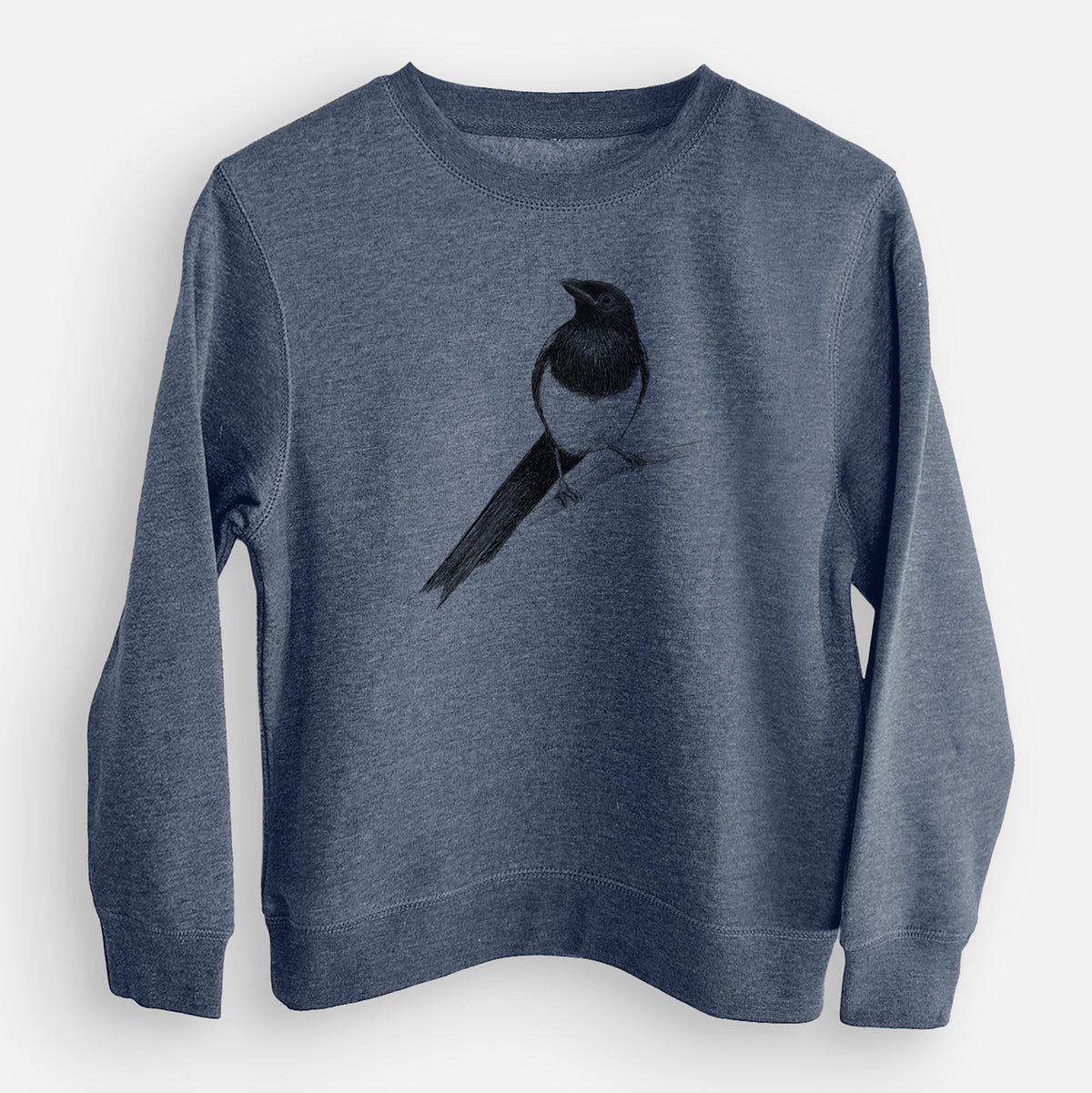 Storm blue youth crewneck sweatshirt laid flat, printed with a detailed black ink sketch of a black-billed magpie perched on a branch with its long tail.