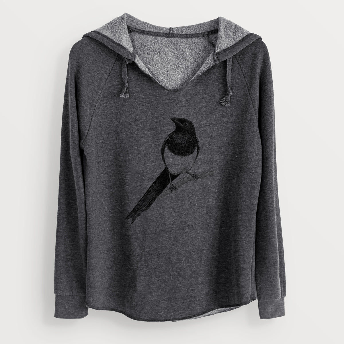 Charcoal grey women's Cali Wave hooded sweatshirt laid flat, printed with a detailed black ink sketch of a black-billed magpie perched on a branch with its long tail.