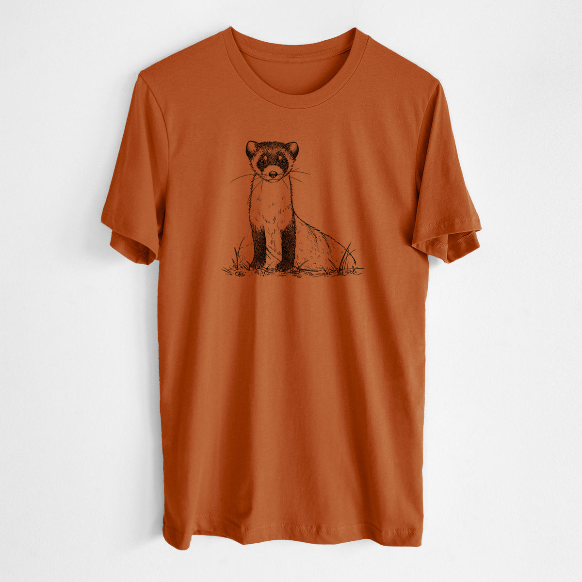 Autumn lightweight cotton t-shirt laid flat, printed with a detailed black ink illustration of a black-footed ferret sitting on the ground.