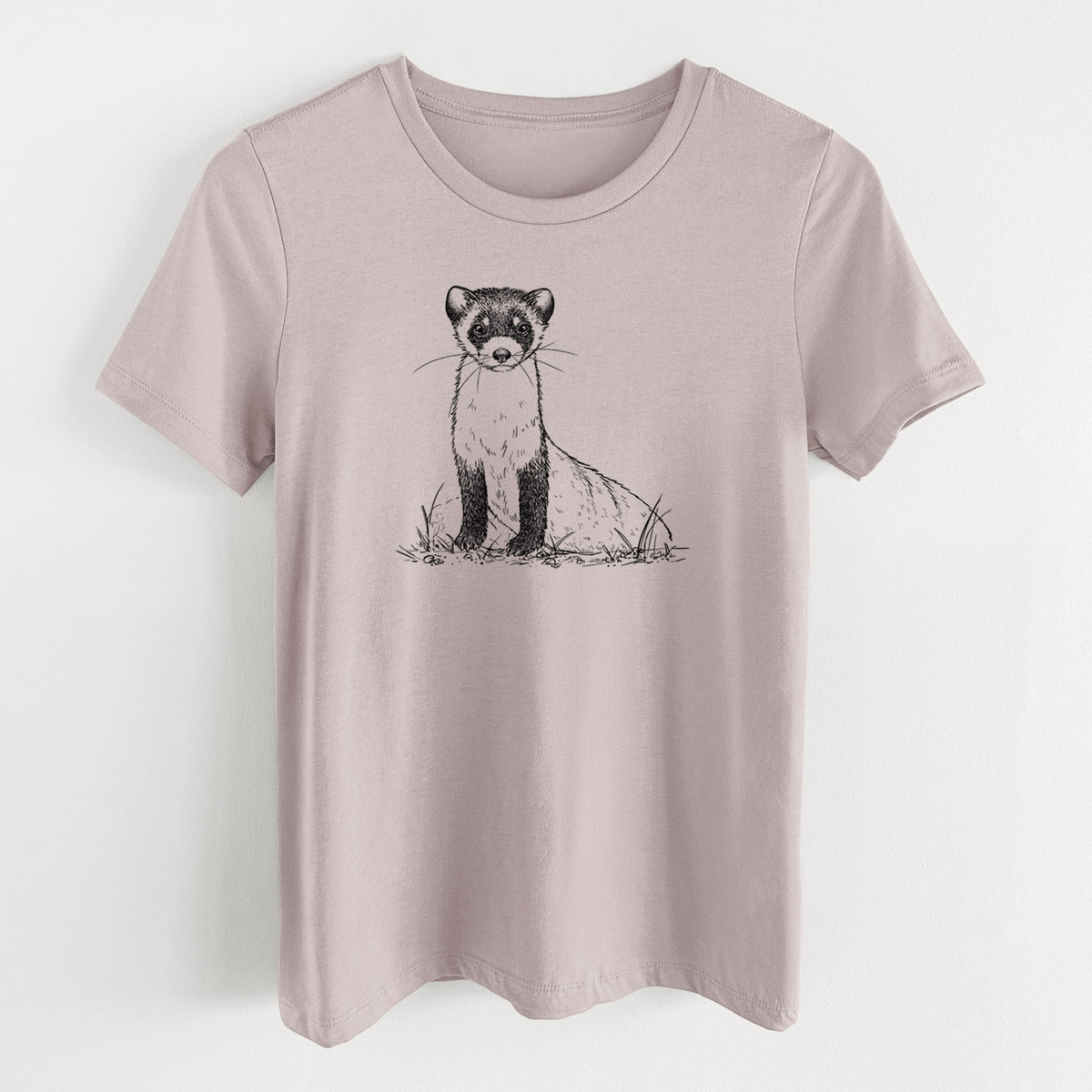 Pink gravel women's relaxed fit cotton t-shirt laid flat, printed with a detailed black ink illustration of a black-footed ferret sitting on the ground.