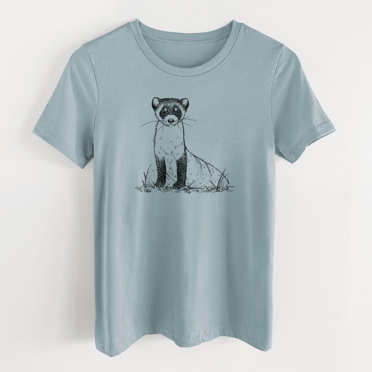 Vintage denim women's relaxed fit cotton t-shirt laid flat, printed with a detailed black ink illustration of a black-footed ferret sitting on the ground.