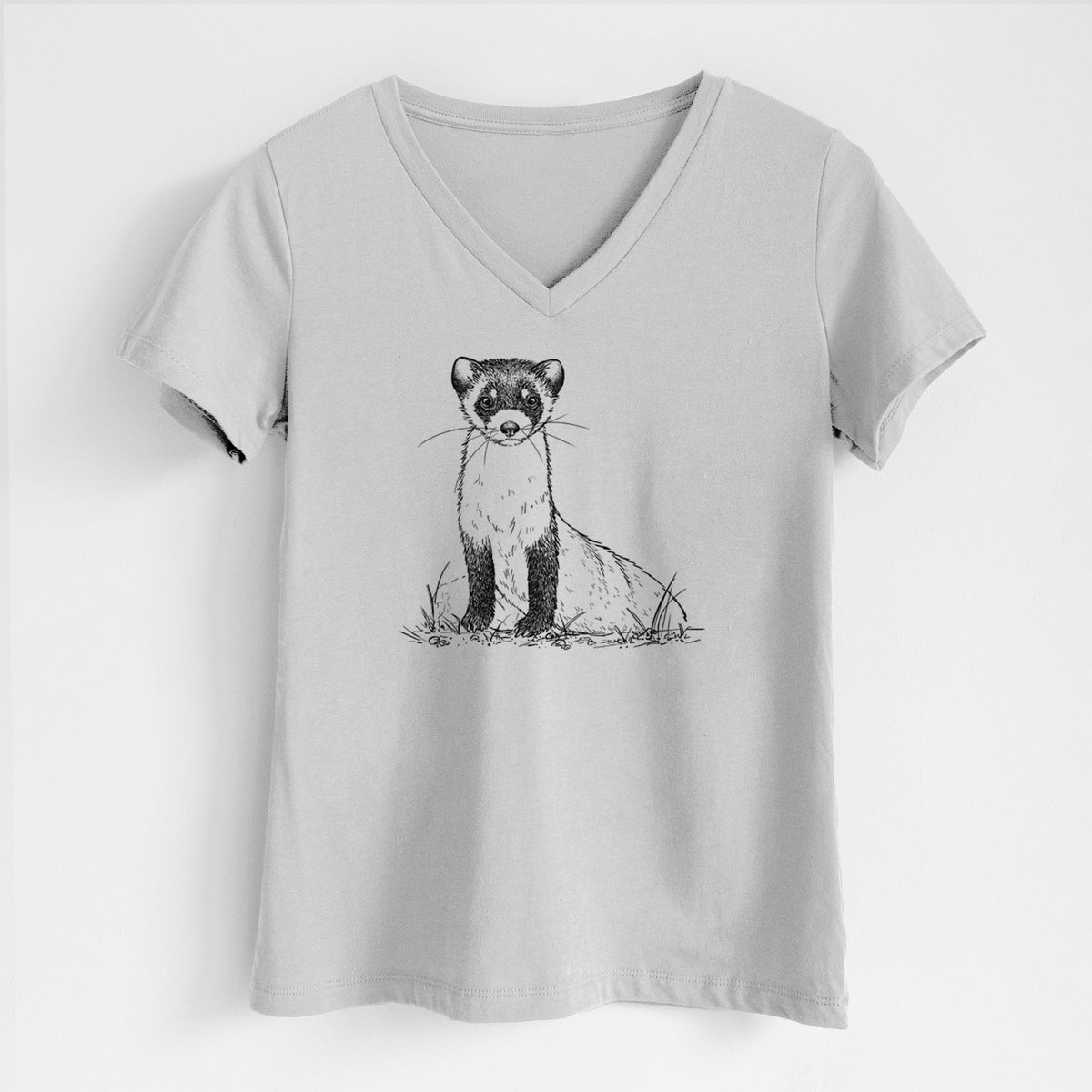Lunar grey women's relaxed fit cotton V-neck t-shirt laid flat, printed with a detailed black ink illustration of a black-footed ferret sitting on the ground.