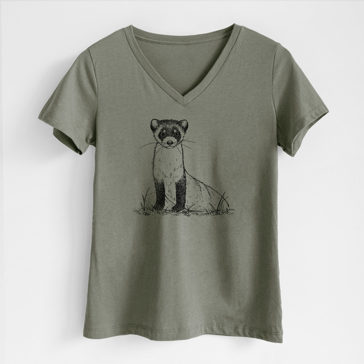 Military green women's relaxed fit cotton V-neck t-shirt laid flat, printed with a detailed black ink illustration of a black-footed ferret sitting on the ground.