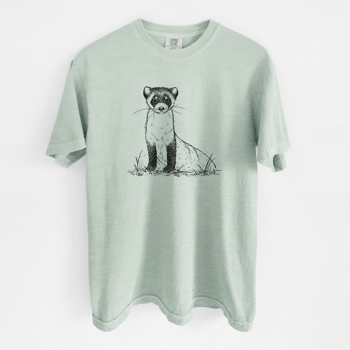 Bay green Comfort Colors t-shirt laid flat, printed with a detailed black ink illustration of a black-footed ferret sitting on the ground.