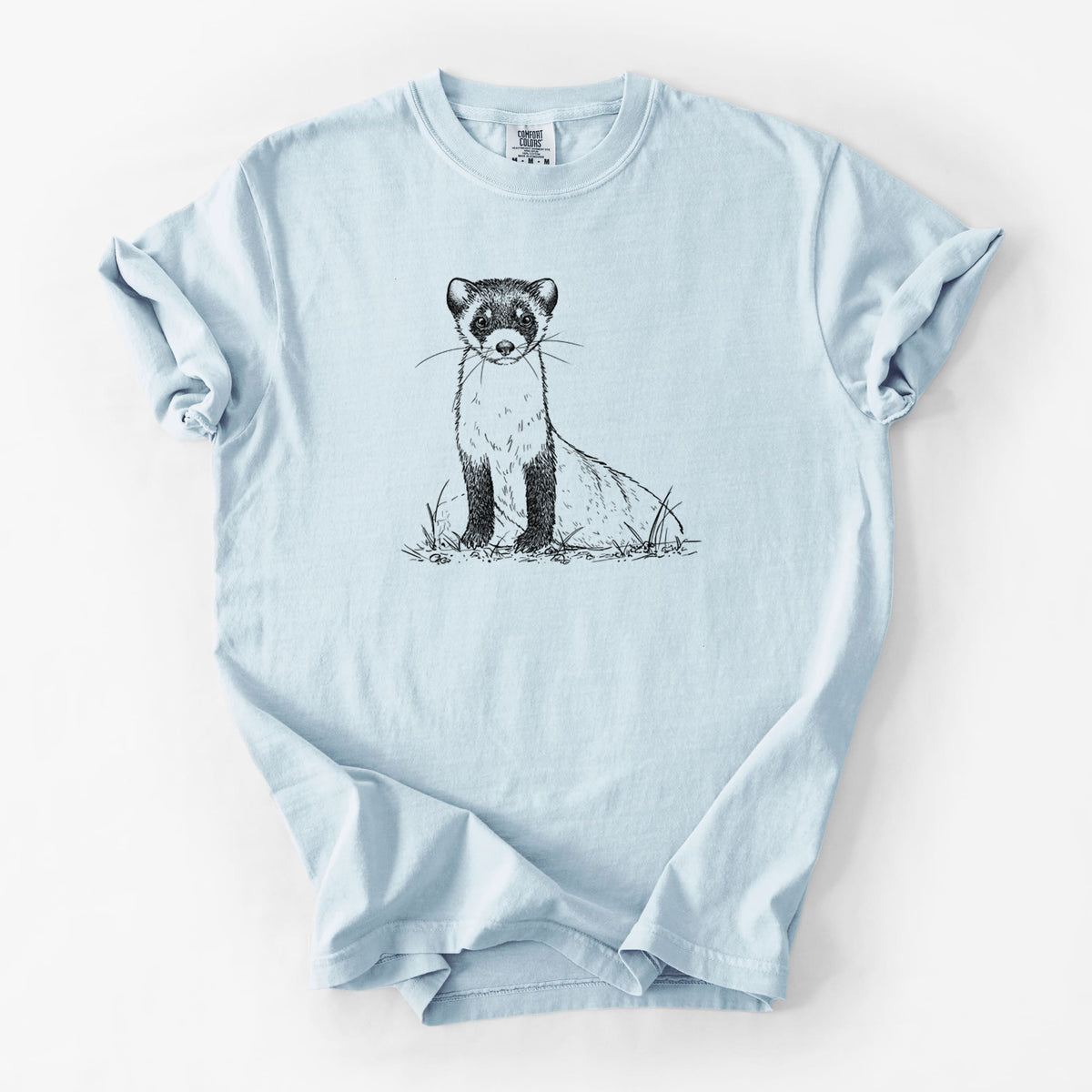 Chambray blue Comfort Colors t-shirt laid flat, printed with a detailed black ink illustration of a black-footed ferret sitting on the ground.