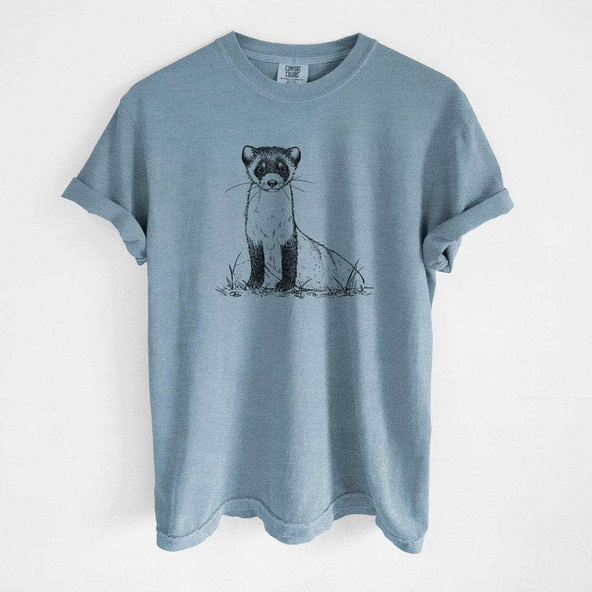 Steel blue Comfort Colors t-shirt laid flat, printed with a detailed black ink illustration of a black-footed ferret sitting on the ground.