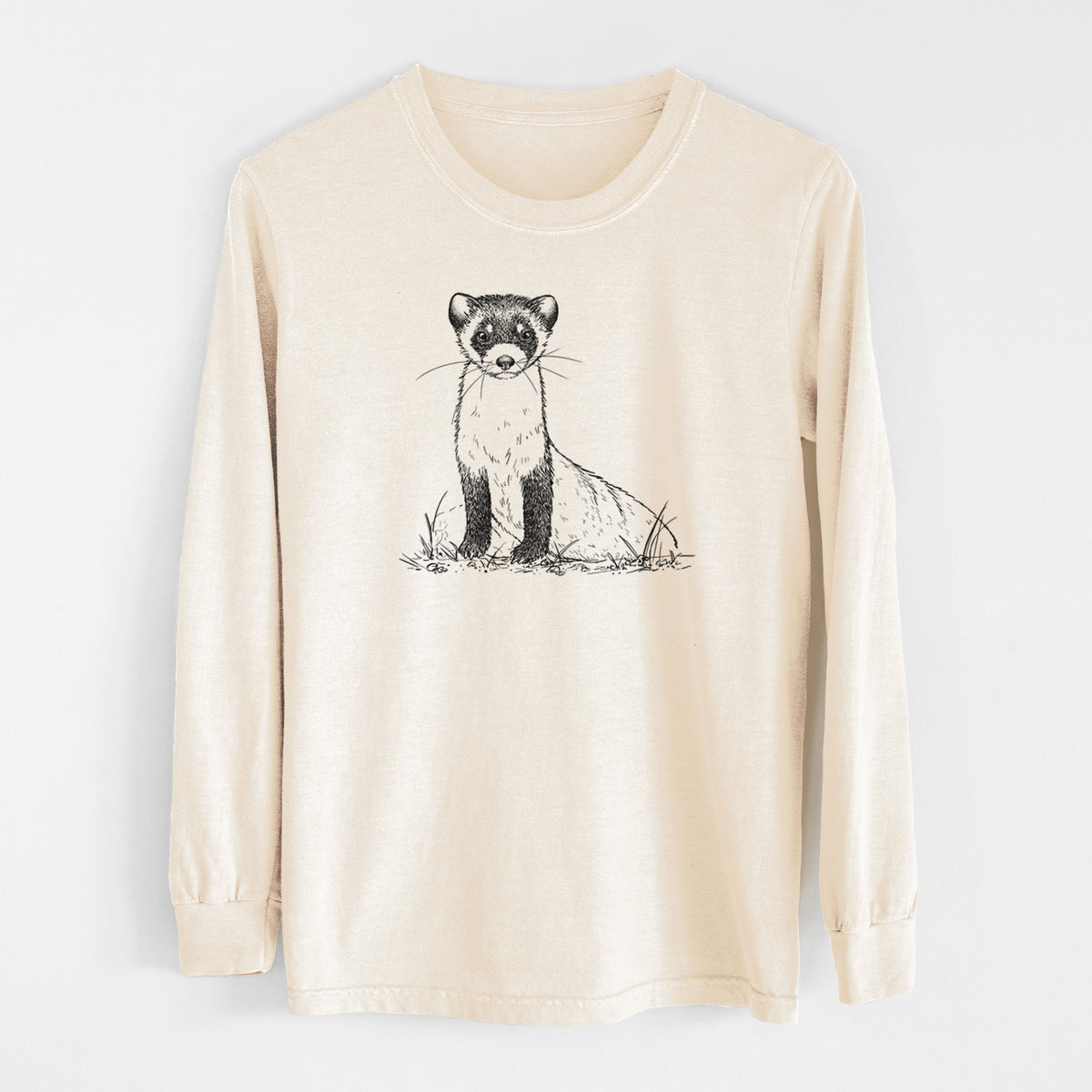 Ivory Comfort Colors long sleeve shirt laid flat, printed with a detailed black ink illustration of a black-footed ferret sitting on the ground.