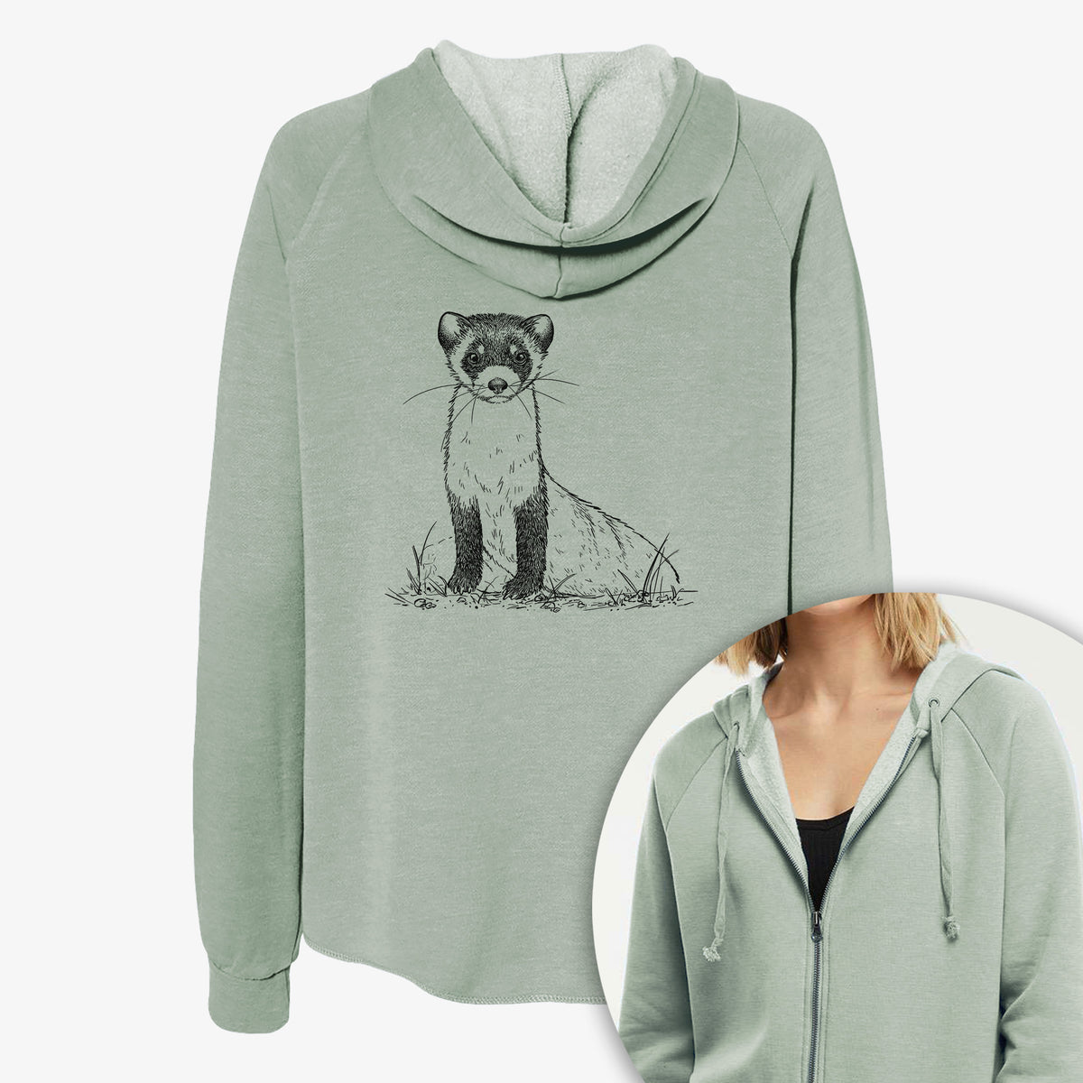 Women's Cali Wave zip-up sweatshirt printed with a detailed black ink illustration of a black-footed ferret sitting on the ground, with a close-up of the zipper.