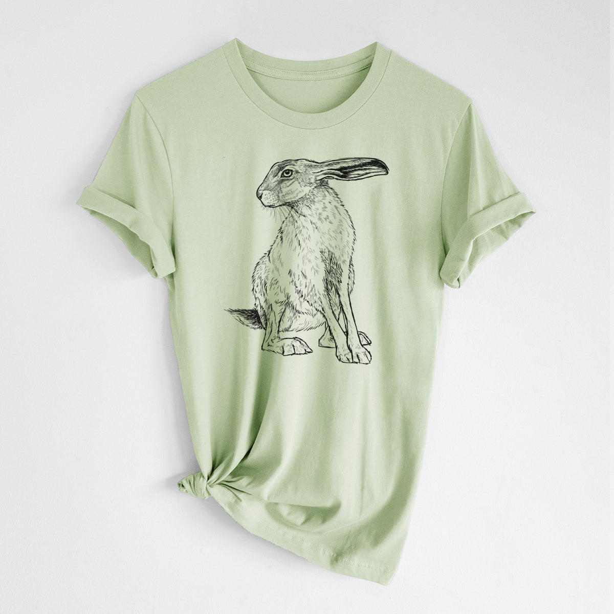 Spring green lightweight cotton t-shirt laid flat with the sleeves rolled, printed with a detailed black ink illustration of a black-tailed jackrabbit sitting with long upright ears.