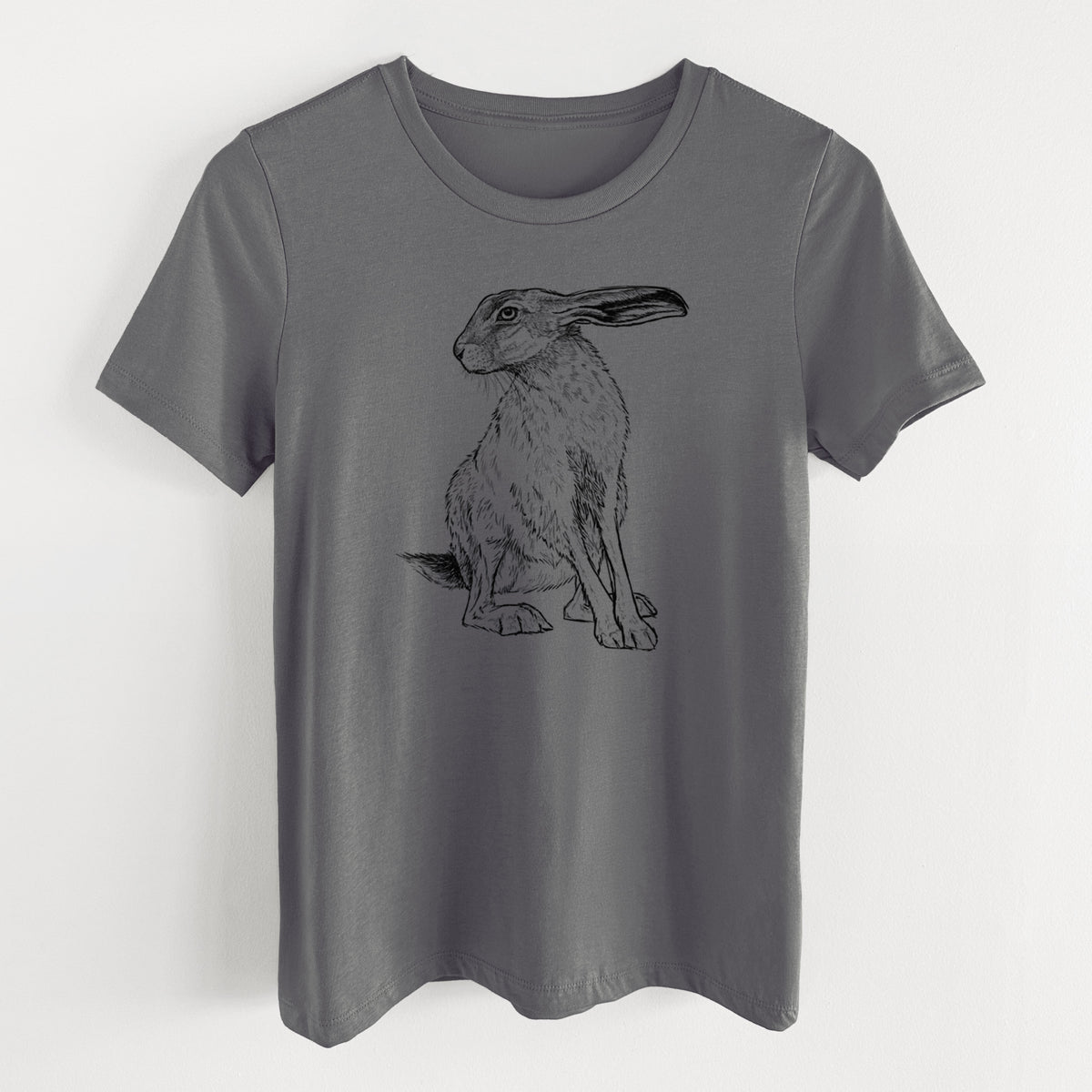 Asphalt women's relaxed fit cotton t-shirt laid flat, printed with a detailed black ink illustration of a black-tailed jackrabbit sitting with long upright ears.