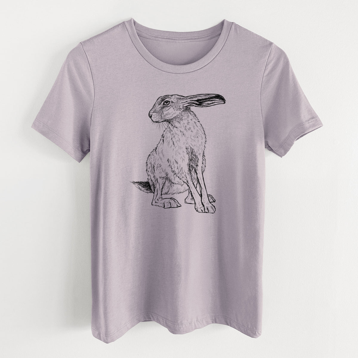 Light violet women's relaxed fit cotton t-shirt laid flat, printed with a detailed black ink illustration of a black-tailed jackrabbit sitting with long upright ears.