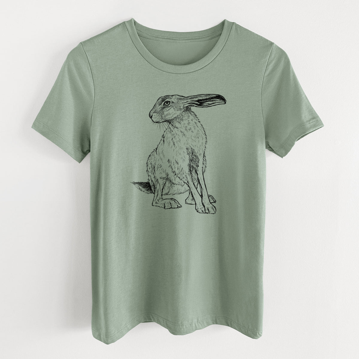 Sage green women's relaxed fit cotton t-shirt laid flat, printed with a detailed black ink illustration of a black-tailed jackrabbit sitting with long upright ears.