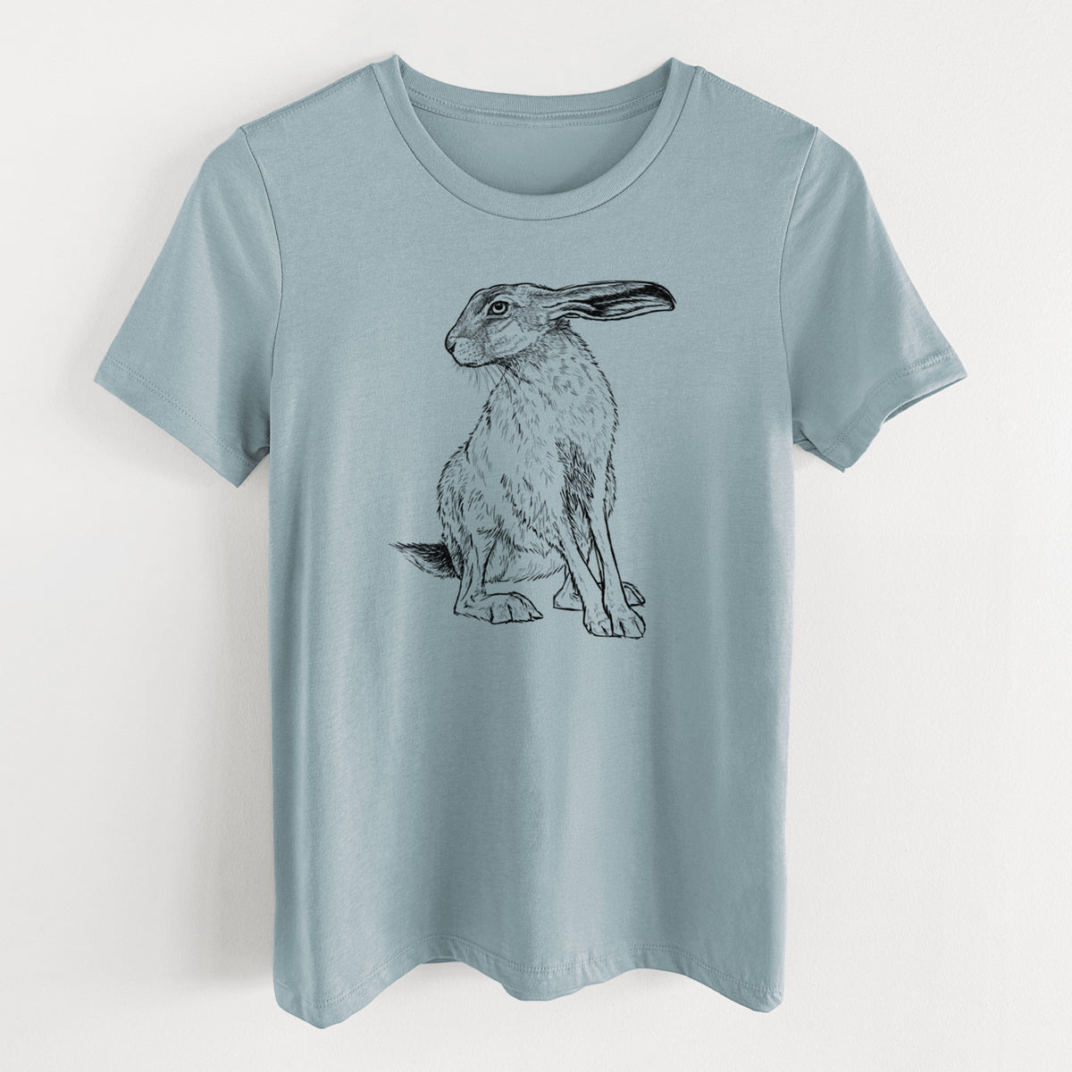 Vintage denim women's relaxed fit cotton t-shirt laid flat, printed with a detailed black ink illustration of a black-tailed jackrabbit sitting with long upright ears.