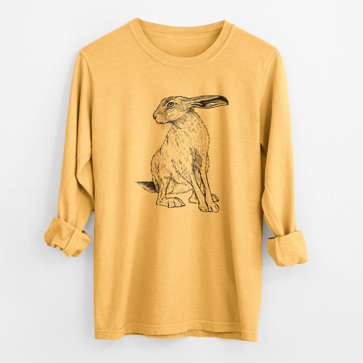 Golden wheat yellow Comfort Colors long sleeve shirt laid flat with the cuffs rolled, printed with a detailed black ink illustration of a black-tailed jackrabbit sitting with long upright ears.