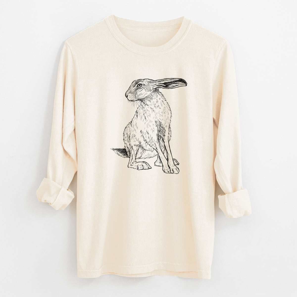 Ivory Comfort Colors long sleeve shirt laid flat with the cuffs rolled, printed with a detailed black ink illustration of a black-tailed jackrabbit sitting with long upright ears.