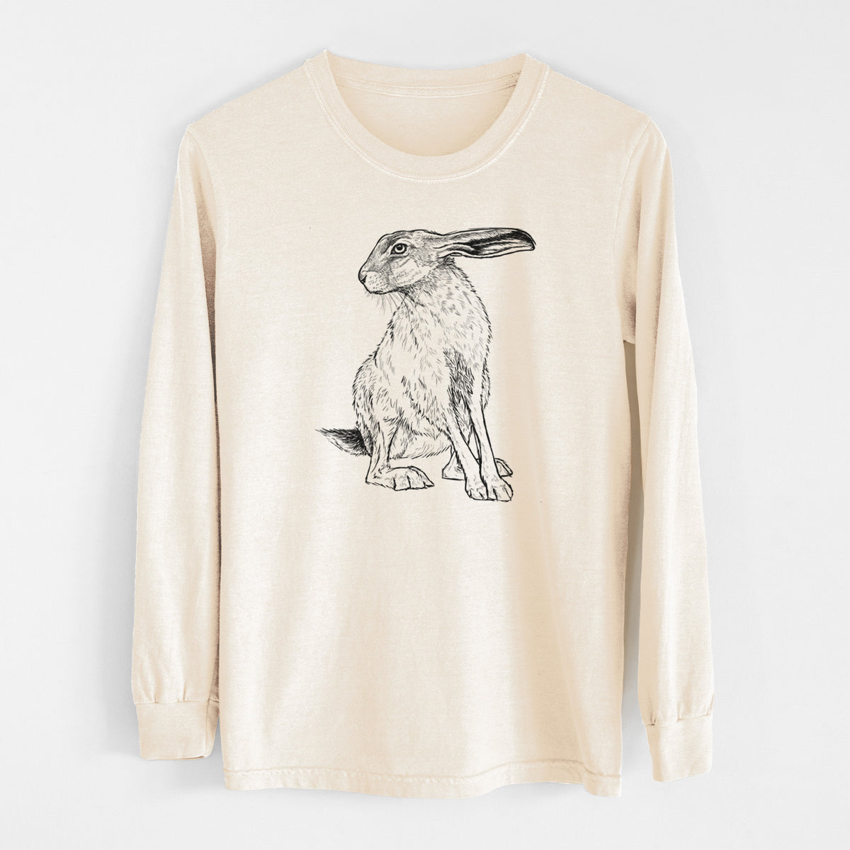Ivory Comfort Colors long sleeve shirt laid flat, printed with a detailed black ink illustration of a black-tailed jackrabbit sitting with long upright ears.
