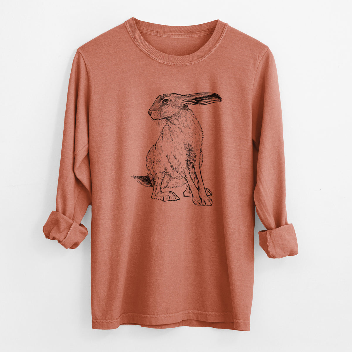 Yam burnt orange Comfort Colors long sleeve shirt laid flat with the cuffs rolled, printed with a detailed black ink illustration of a black-tailed jackrabbit sitting with long upright ears.