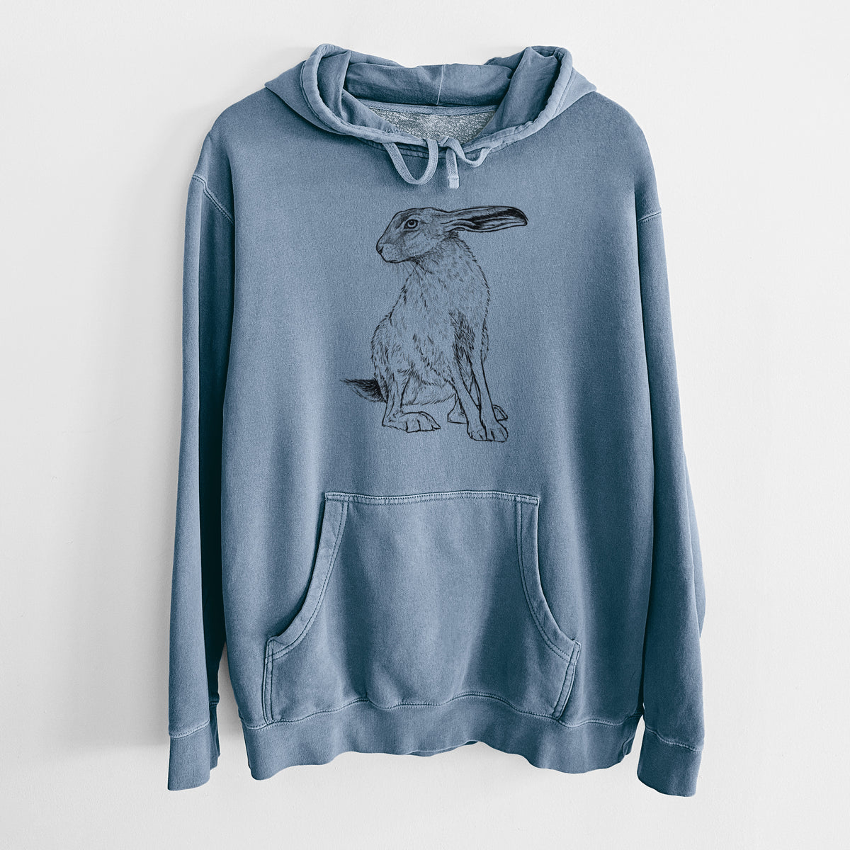 Slate blue pigment dyed hoodie laid flat, printed with a detailed black ink illustration of a black-tailed jackrabbit sitting with long upright ears.