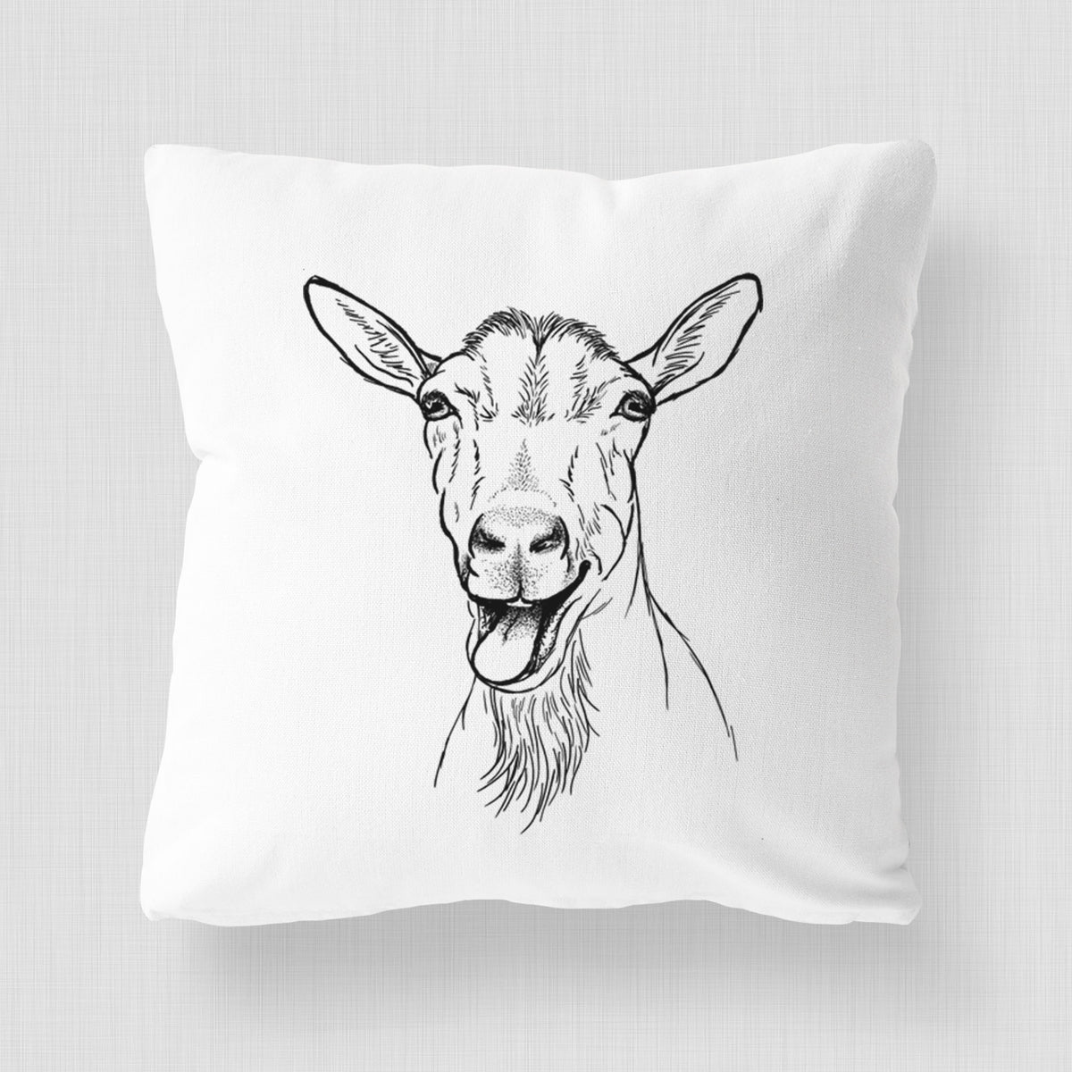 White pillow cover printed with a black ink illustration of a goat's head with its mouth open mid-bleat and its tongue out.