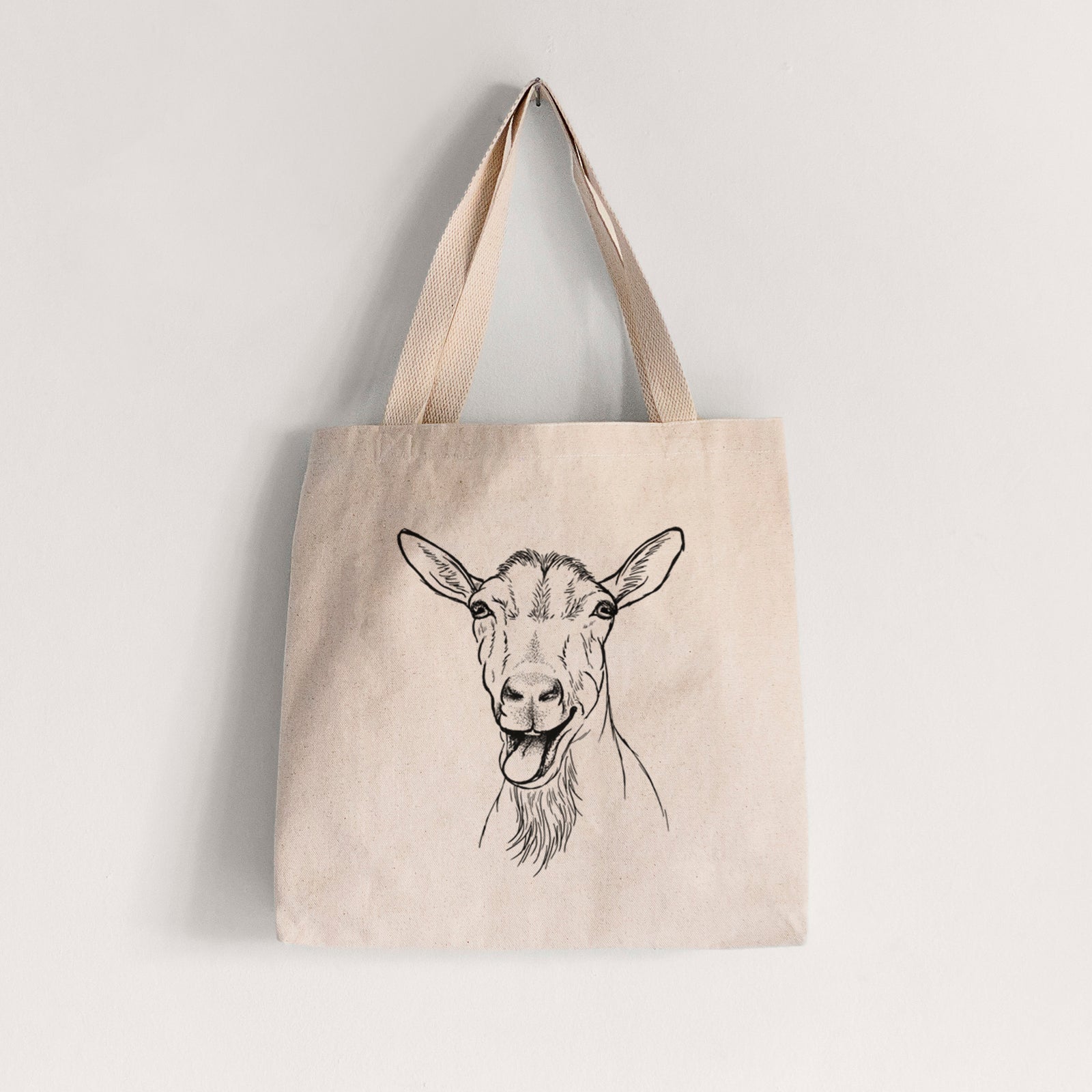 Natural canvas tote bag printed with a black ink illustration of a goat's head with its mouth open mid-bleat and its tongue out.