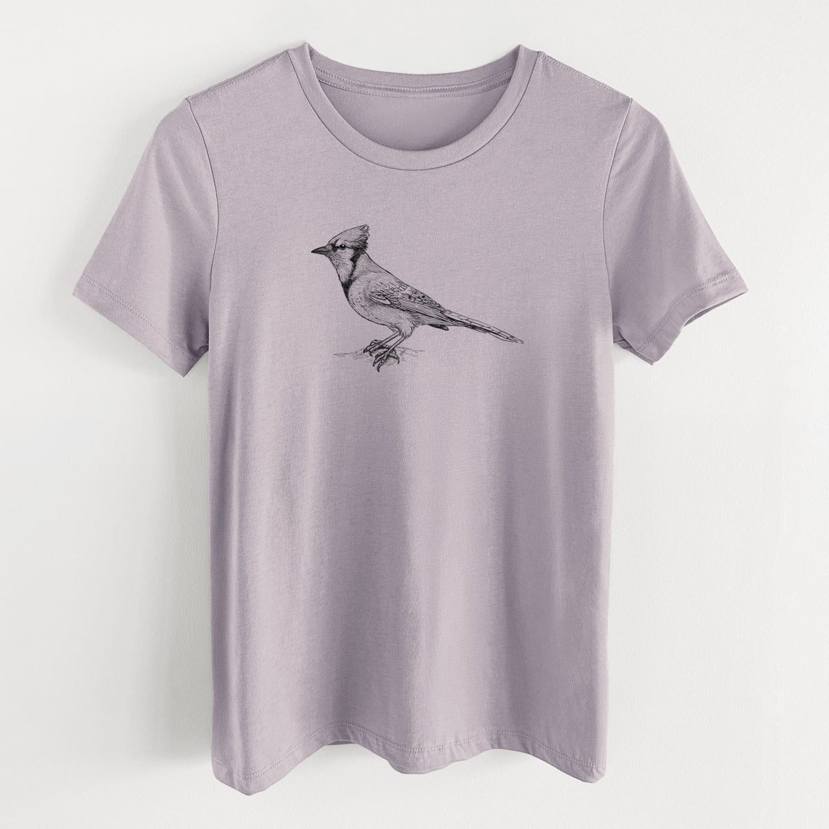 Light violet women's relaxed fit cotton t-shirt laid flat, printed with a detailed black ink sketch of a blue jay perched with its crest raised.