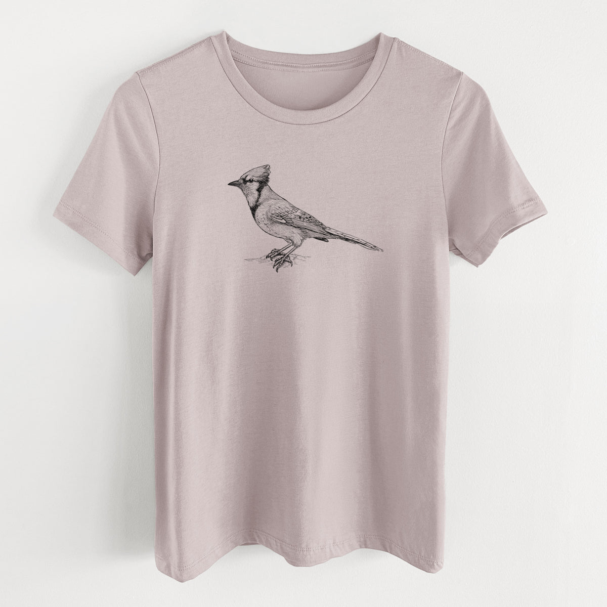 Pink gravel women's relaxed fit cotton t-shirt laid flat, printed with a detailed black ink sketch of a blue jay perched with its crest raised.