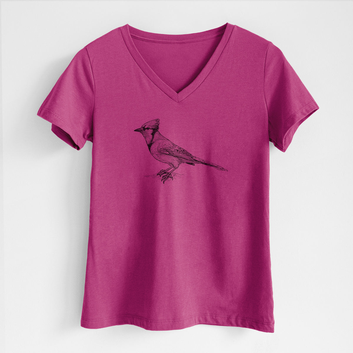 Berry pink women's relaxed fit cotton V-neck t-shirt laid flat, printed with a detailed black ink sketch of a blue jay perched with its crest raised.