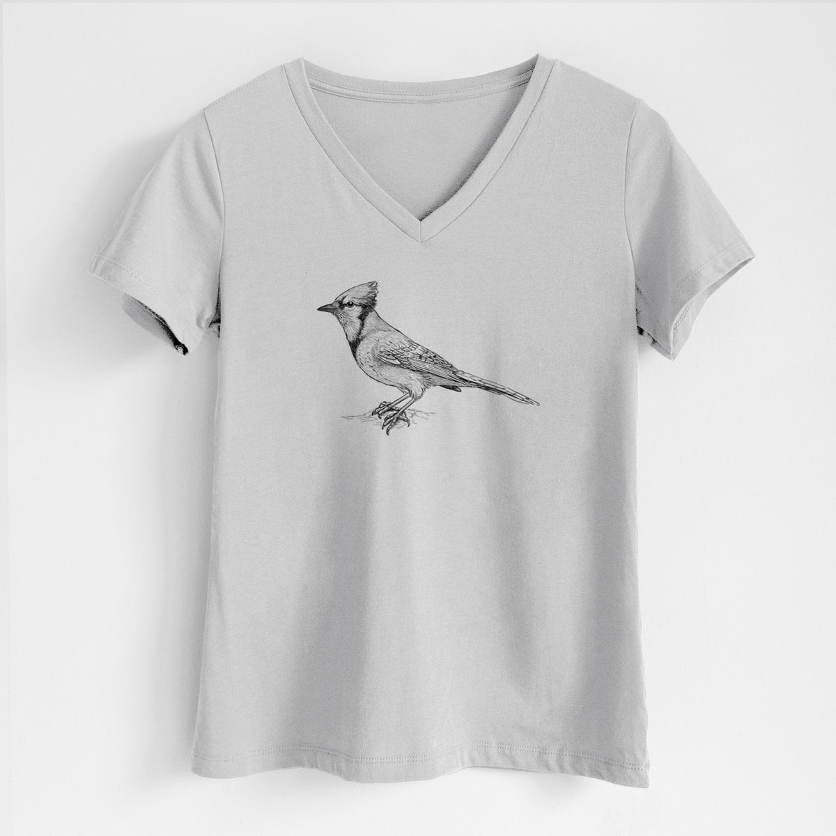 Lunar grey women's relaxed fit cotton V-neck t-shirt laid flat, printed with a detailed black ink sketch of a blue jay perched with its crest raised.